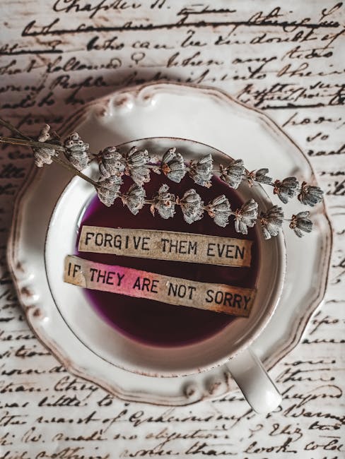 Flat lay of a teacup with lavender and an inspirational message, set against cursive text background.